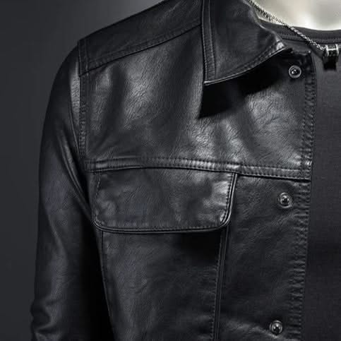 Black leather jacket chest detail with flap pocket and snap buttons.