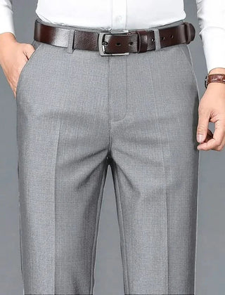 Gray dress trousers with belt loops, zip fly, and straight-leg crease lines.