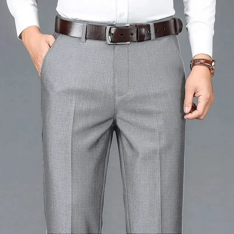 Gray dress trousers with belt loops, zip fly, and straight-leg crease lines.