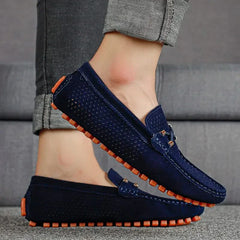 Dark blue perforated leather loafer with metal bar detail and orange-rim tread
