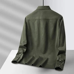 Back view of green canvas overshirt with flap collar and button cuffs