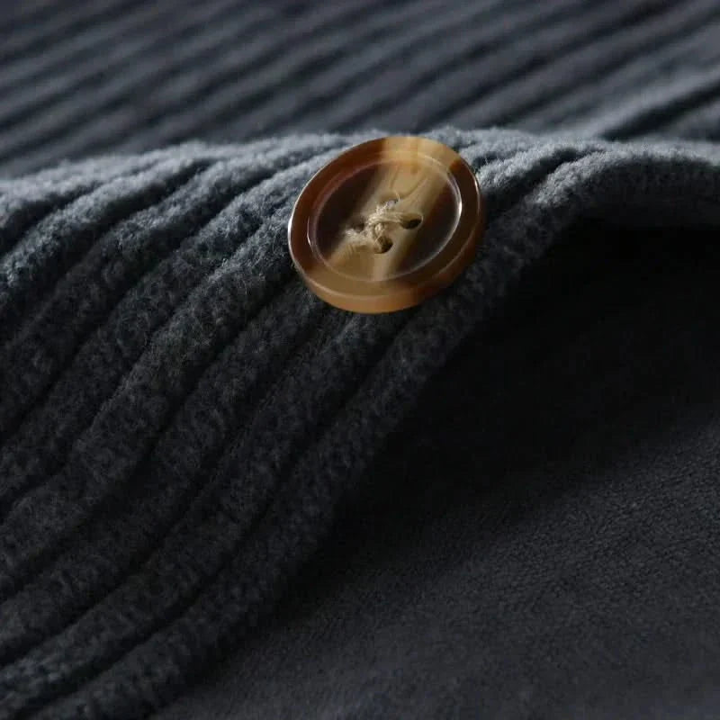 Navy corduroy fabric with round brown button close-up