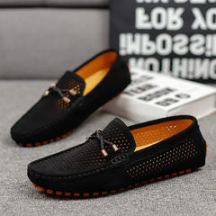 Black perforated leather loafer with metal bar detail and orange-rim tread