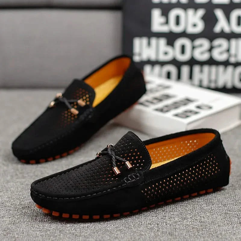 Black perforated leather loafer with metal bar detail and orange-rim tread