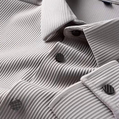 Light gray business shirt close-up, textured weave and dark buttons near cuffs