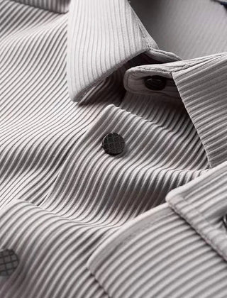 Light gray business shirt close-up, textured weave and dark buttons near cuffs