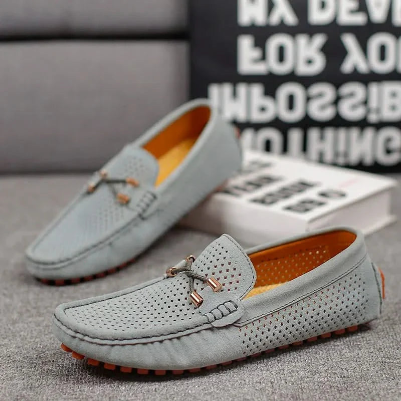 Light gray perforated leather loafer with metal bar detail and orange-rim tread