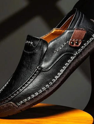 Black leather slip-on loafer with stitched moc toe and metal bit detail