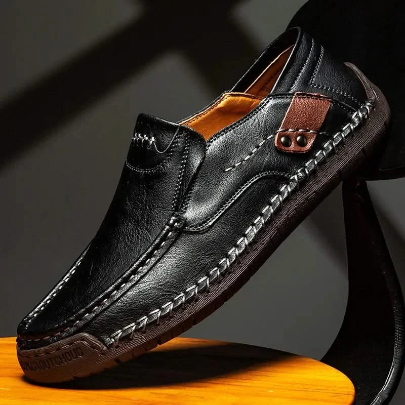 Black leather slip-on loafer with stitched moc toe and metal bit detail
