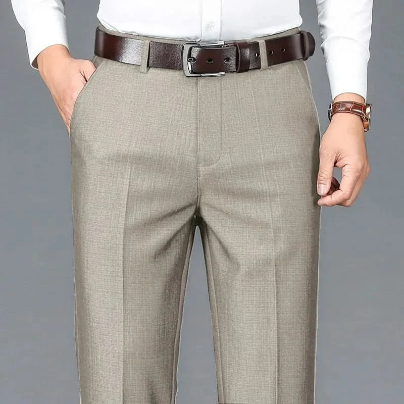 Beige dress trousers with belt loops, zip fly, and front crease detailing.