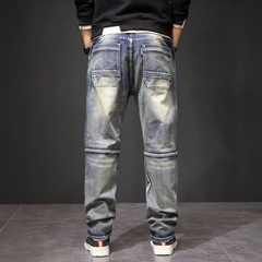 Men's straight jeans, medium blue wash with two thigh flap pockets and elastic cuff hems