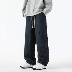 Dark navy quilted pants with raised oval pattern and drawstring waist and hem.