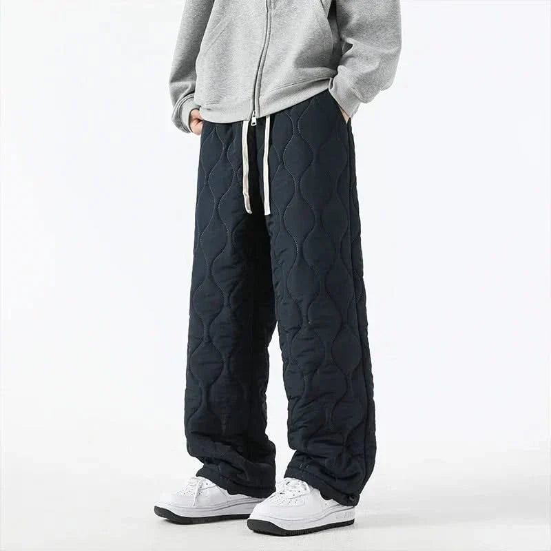 Dark navy quilted pants with raised oval pattern and drawstring waist and hem.