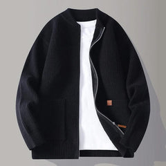 Black rib knit zip-up jacket with stand collar, front pockets, and tan logo patch