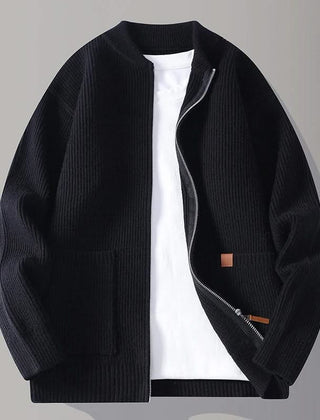 Black rib knit zip-up jacket with stand collar, front pockets, and tan logo patch
