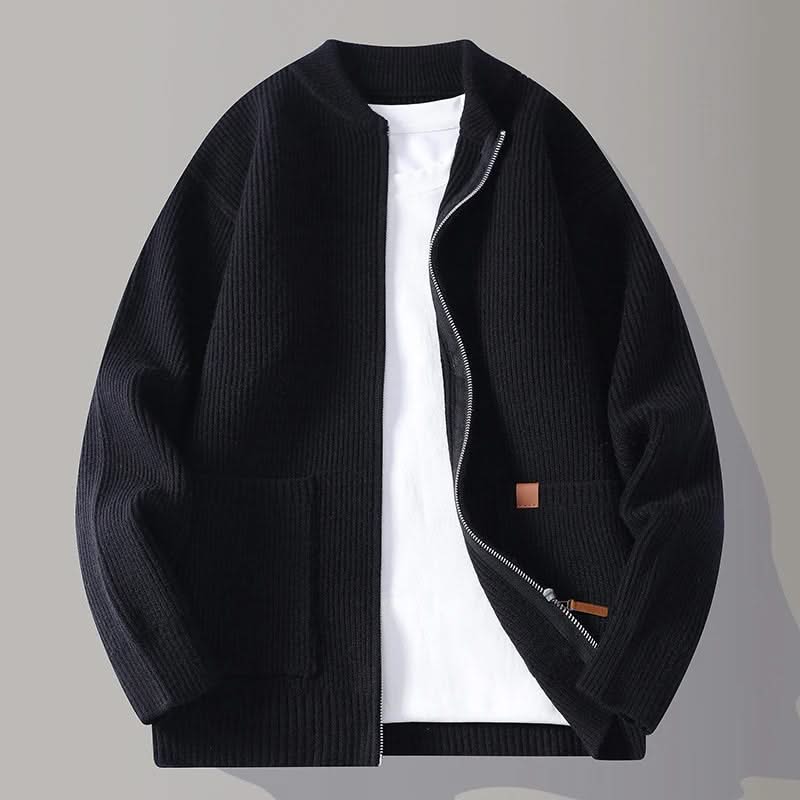 Black rib knit zip-up jacket with stand collar, front pockets, and tan logo patch