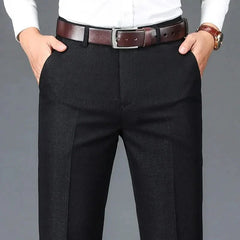 Black dress trousers with belt loops, zip fly, and straight slim fit legs.
