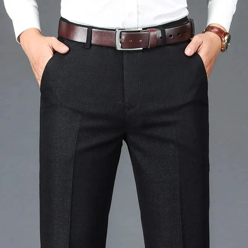 Black dress trousers with belt loops, zip fly, and straight slim fit legs.