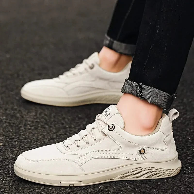 White leather-look lace-up sneakers with perforated side panel and low rubber sole