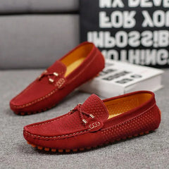 Red perforated leather loafer slip-on with metal bar detail and orange tread