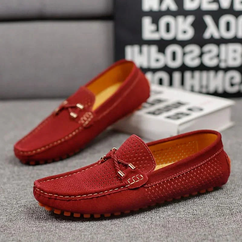 Red perforated leather loafer slip-on with metal bar detail and orange tread