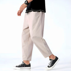 Khaki-beige cropped cotton pants with drawstring waist and relaxed tapered fit