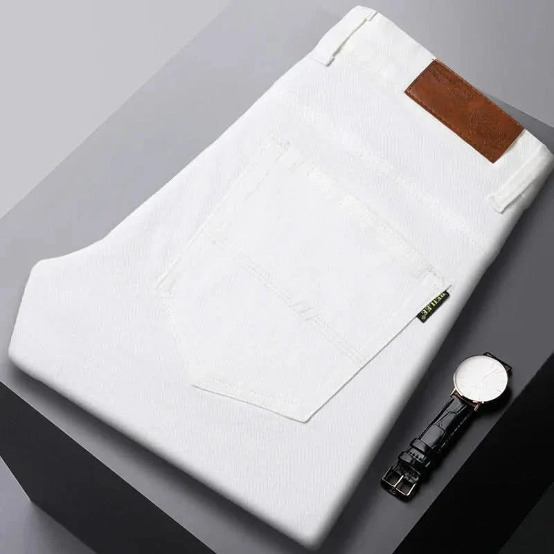 White denim jeans folded flat, visible front pocket and brown leather logo patch