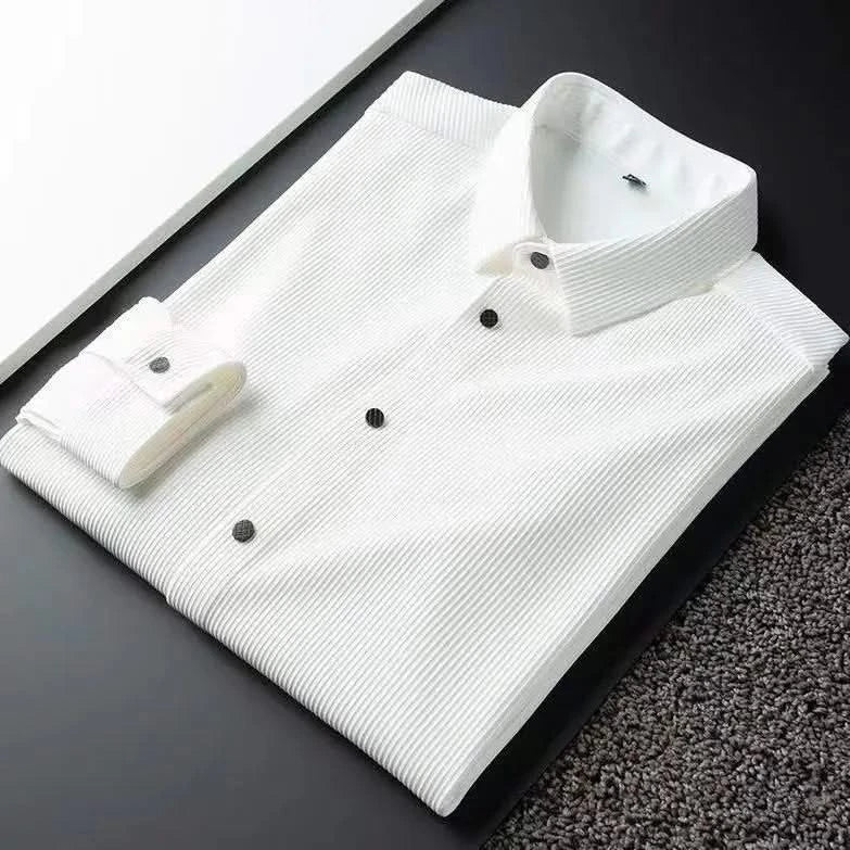 White business shirt folded flat, spread collar and button placket visible
