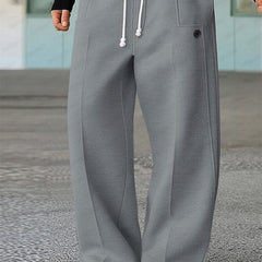 Grey wide-leg trousers with white drawstring, side pockets, and buttoned front detail