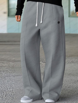 Grey wide-leg trousers with white drawstring, side pockets, and buttoned front detail