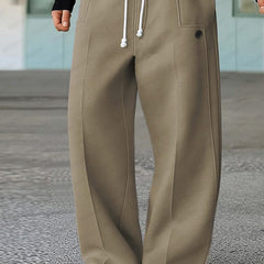 Khaki wide-leg trousers with white drawstring, side pockets, and buttoned front detail