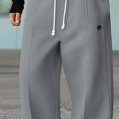 Light grey wide-leg trousers with white drawstring, side pocket, and button detail