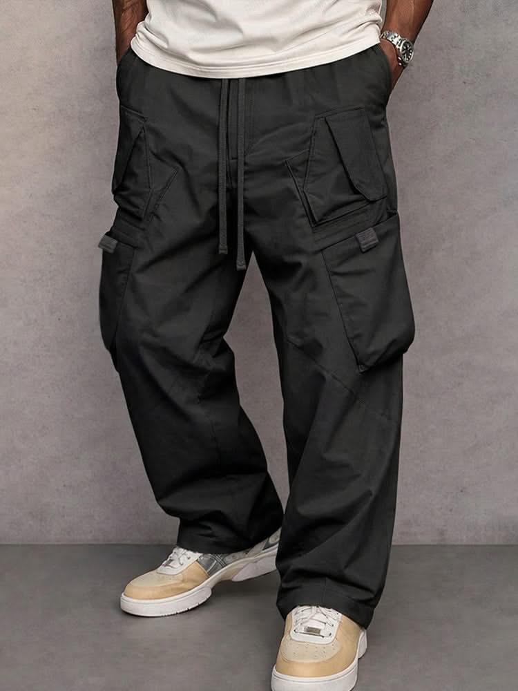 Black utility cargo trousers with drawstring waist and side flap pockets