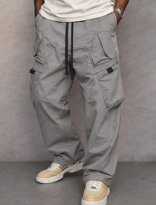 Mid grey utility cargo trousers, full-length front view with drawstring waist and flap pockets