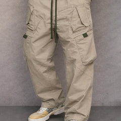 Stone beige utility cargo trousers with drawstring waist and side flap pockets