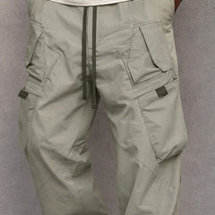 Grey-green utility cargo trousers with drawstring waist and side flap pockets