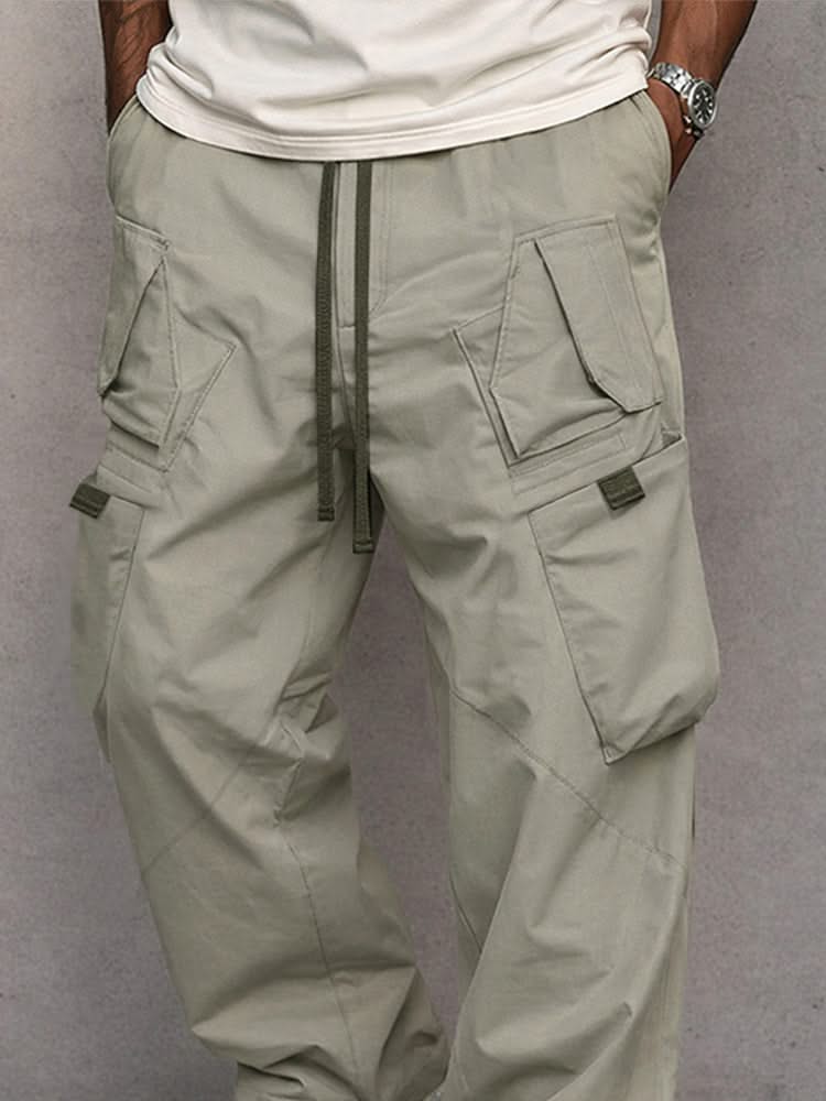 Grey-green utility cargo trousers with drawstring waist and side flap pockets