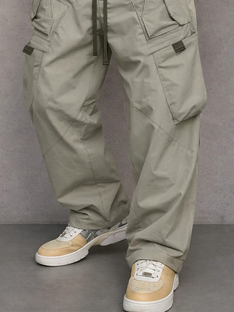 Light grey utility cargo trousers detail view with flap side pockets