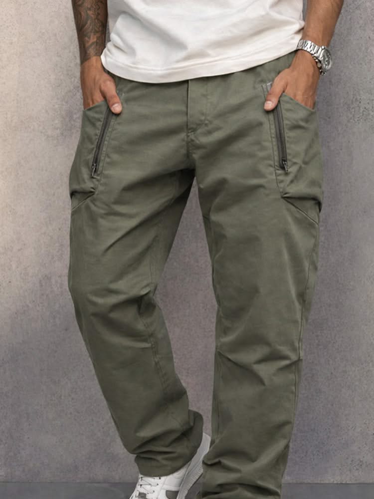 Army green cotton cargo pants with side zip pockets, relaxed tapered legs