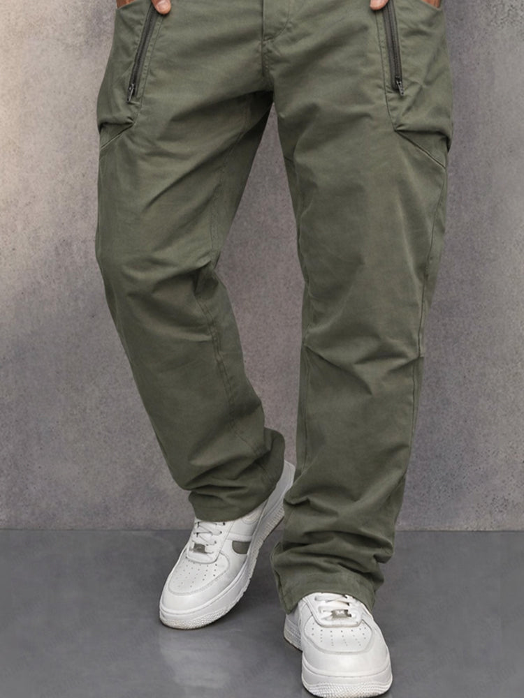 Army green cotton cargo pants with side zip pocket detail, tapered legs