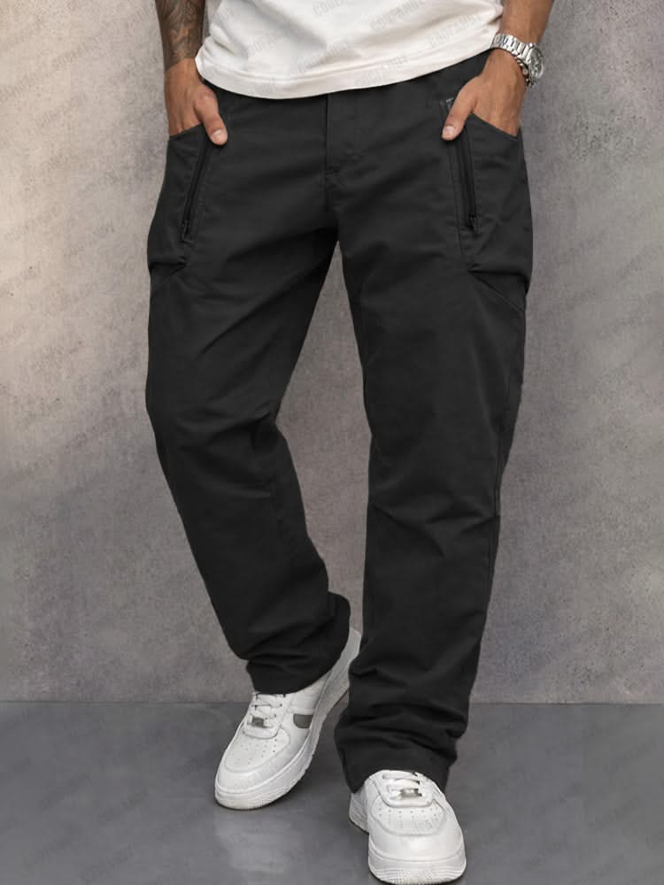 Black cotton cargo pants with side zip pockets, tapered jogger fit