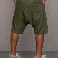 Olive green casual drop-fit shorts, back view with belt loops and pockets.
