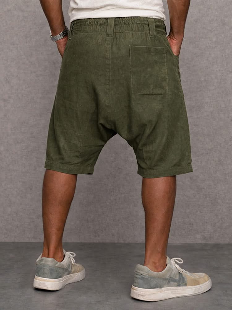 Olive green casual drop-fit shorts, back view with belt loops and pockets.