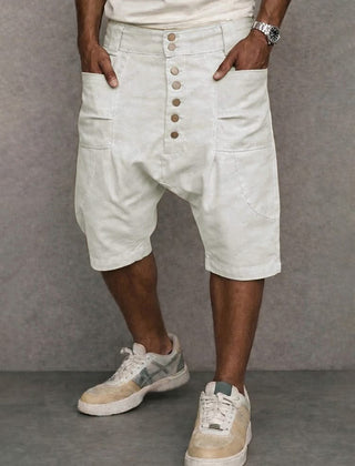 Casual drop-fit shorts in white, front button placket and side pockets.