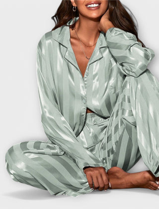 Green satin casual set with button-front shirt and wide-leg striped pants, seated