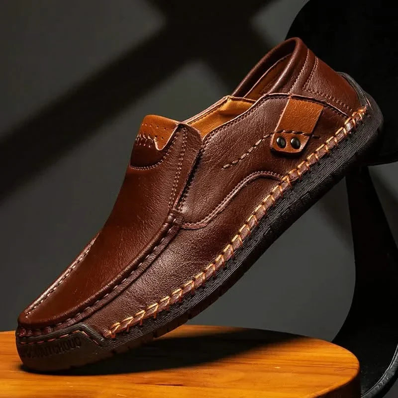 Dark brown leather slip-on loafer with metal bit ornament and contrast stitching