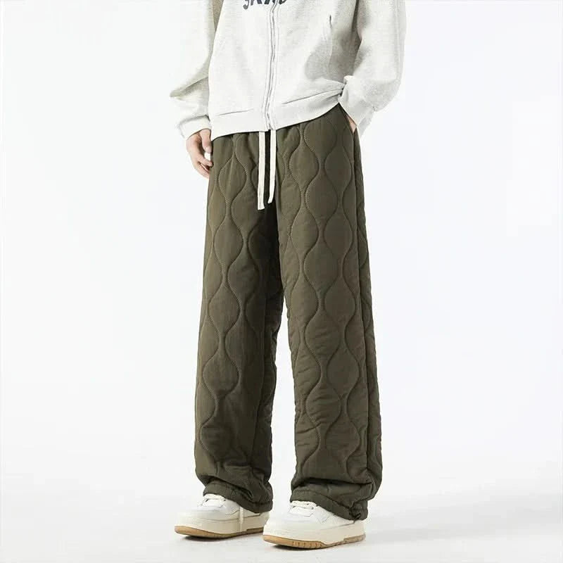 Olive quilted pants with raised oval texture, drawstring waist and wide legs.