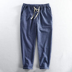 Blue striped linen pants with elastic waistband and drawstring tie, cuffed ankle length