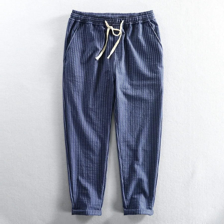Blue striped linen pants with elastic waistband and drawstring tie, cuffed ankle length