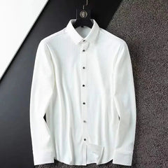 White business shirt on hanger, long sleeves with button-down front and collar